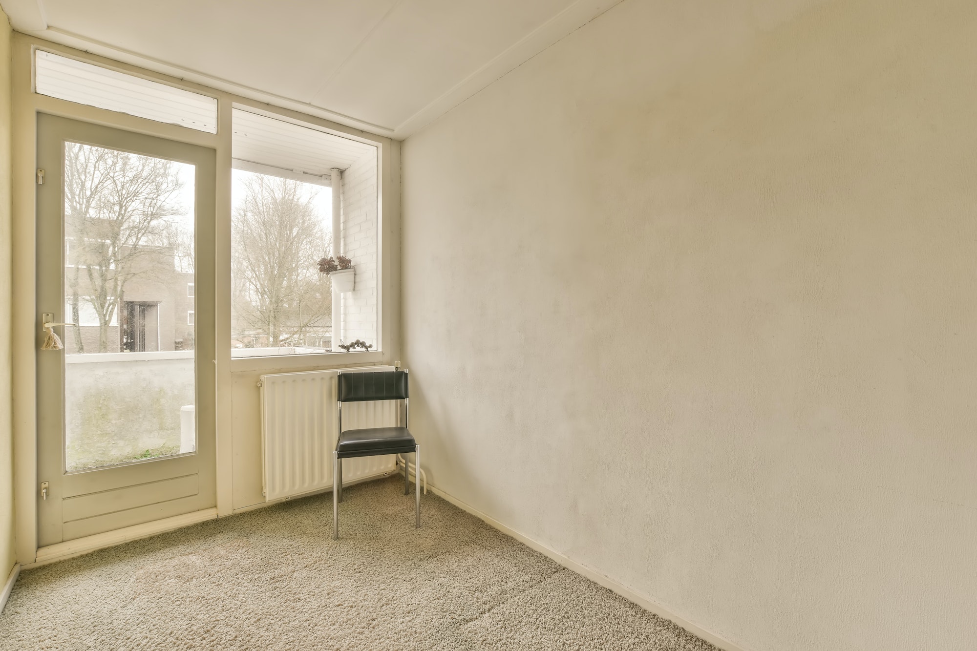 A small empty room with a large window